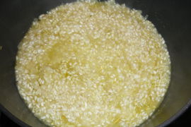 Zuerst die Zwiebel, dann den Reis in der Butter glasig dünsten.